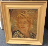 A framed portrait on board of a lady with blond ha