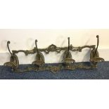 An unusual brass coat hook mount decorated with sc