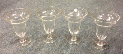 A set of four tapering glass sundae dishes etc. Es