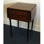 An early Victorian mahogany Pembroke table on four