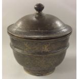 A heavy Chinese brass tapering urn and cover with