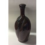 BLANOT: A French red glazed stoneware bottle of sw
