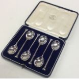 A boxed set of six Edwardian nail top silver spoon