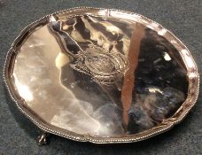 A large Georgian silver salver with beaded rim to