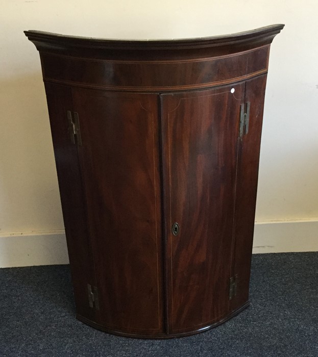 A Georgian mahogany bow front corner cabinet. Est. - Image 2 of 2