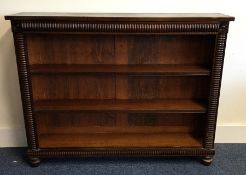 A Victorian mahogany single drawer bookshelf on bu