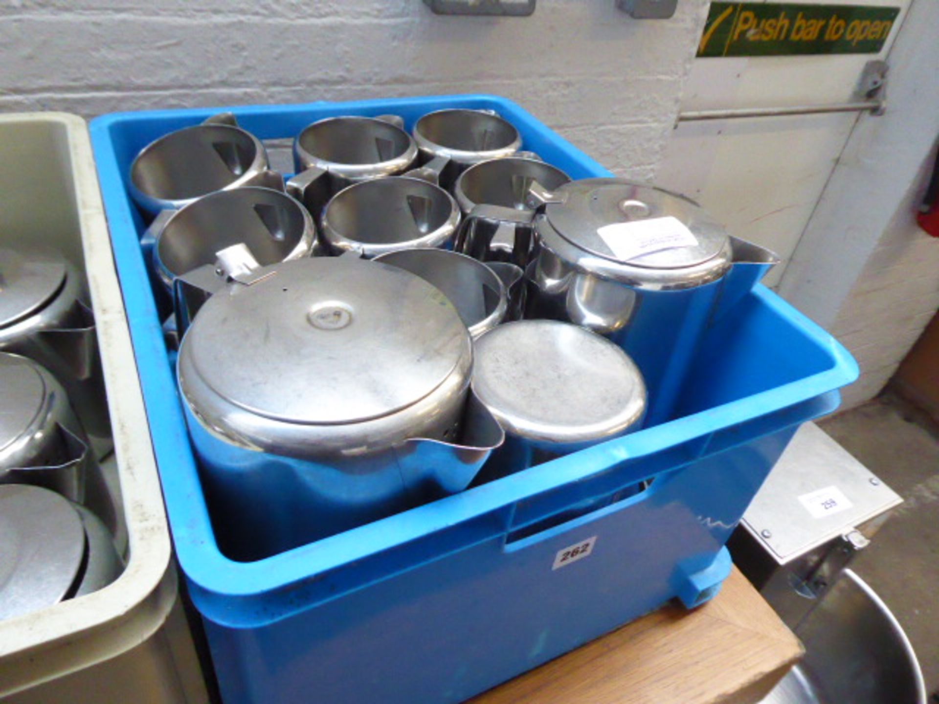 Blue plastic box containing stainless steel coffee pots and large milk jugs