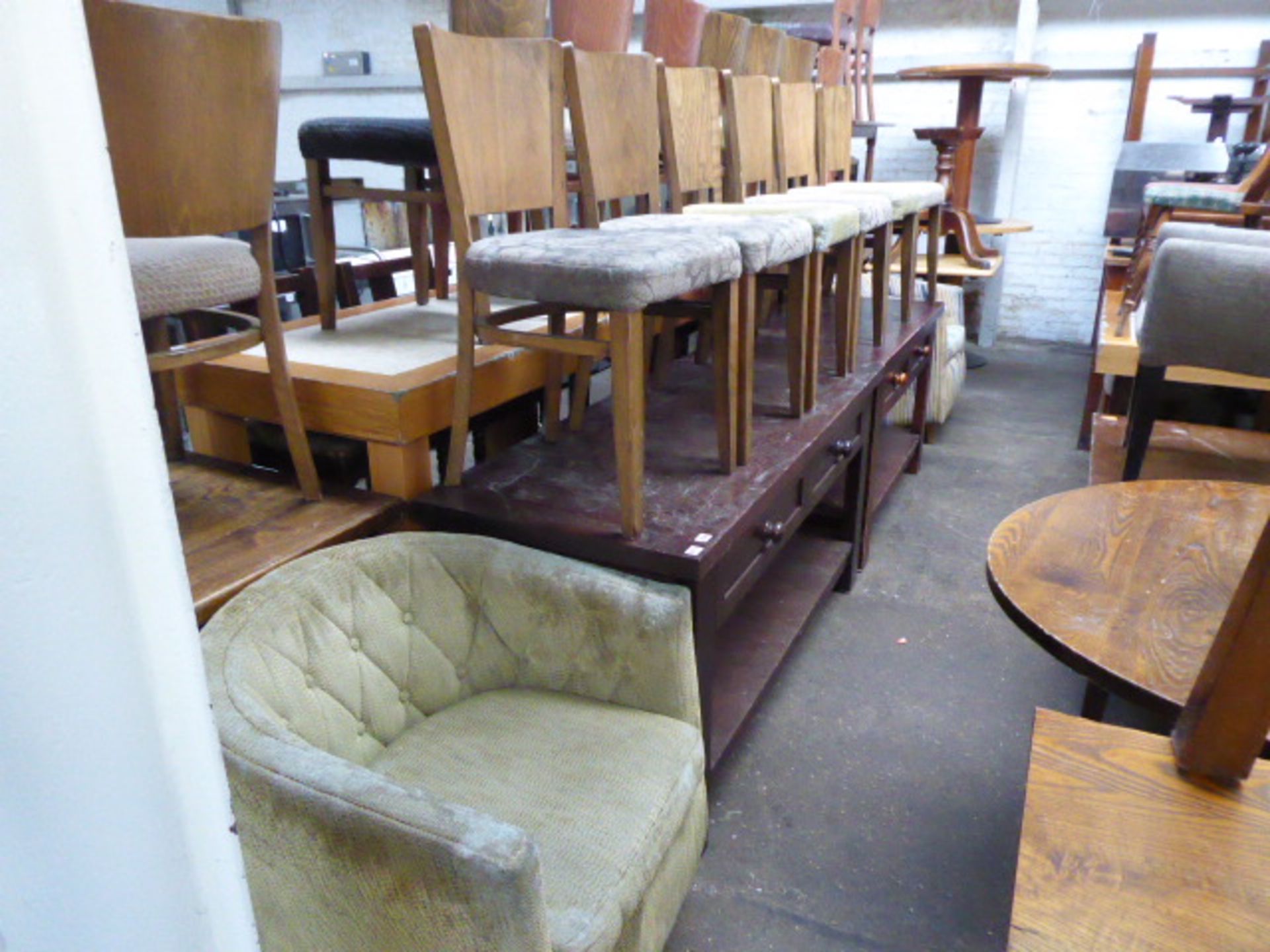 Row of pub furniture comprising 2 low sideboards, 6 dining chairs, 3 tub chairs and part tables
