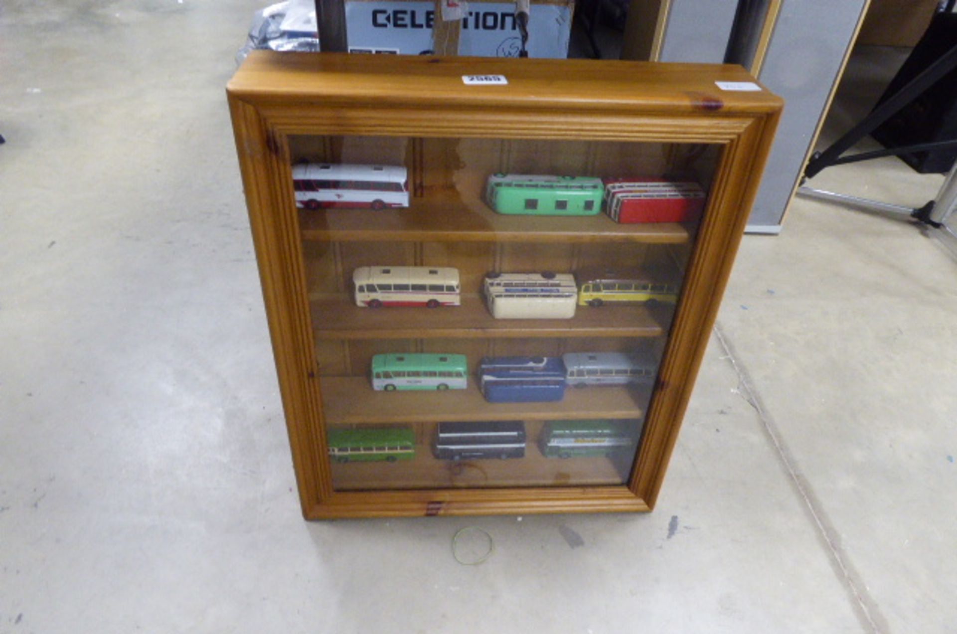 Display case with shelves with various die cast buses, 12