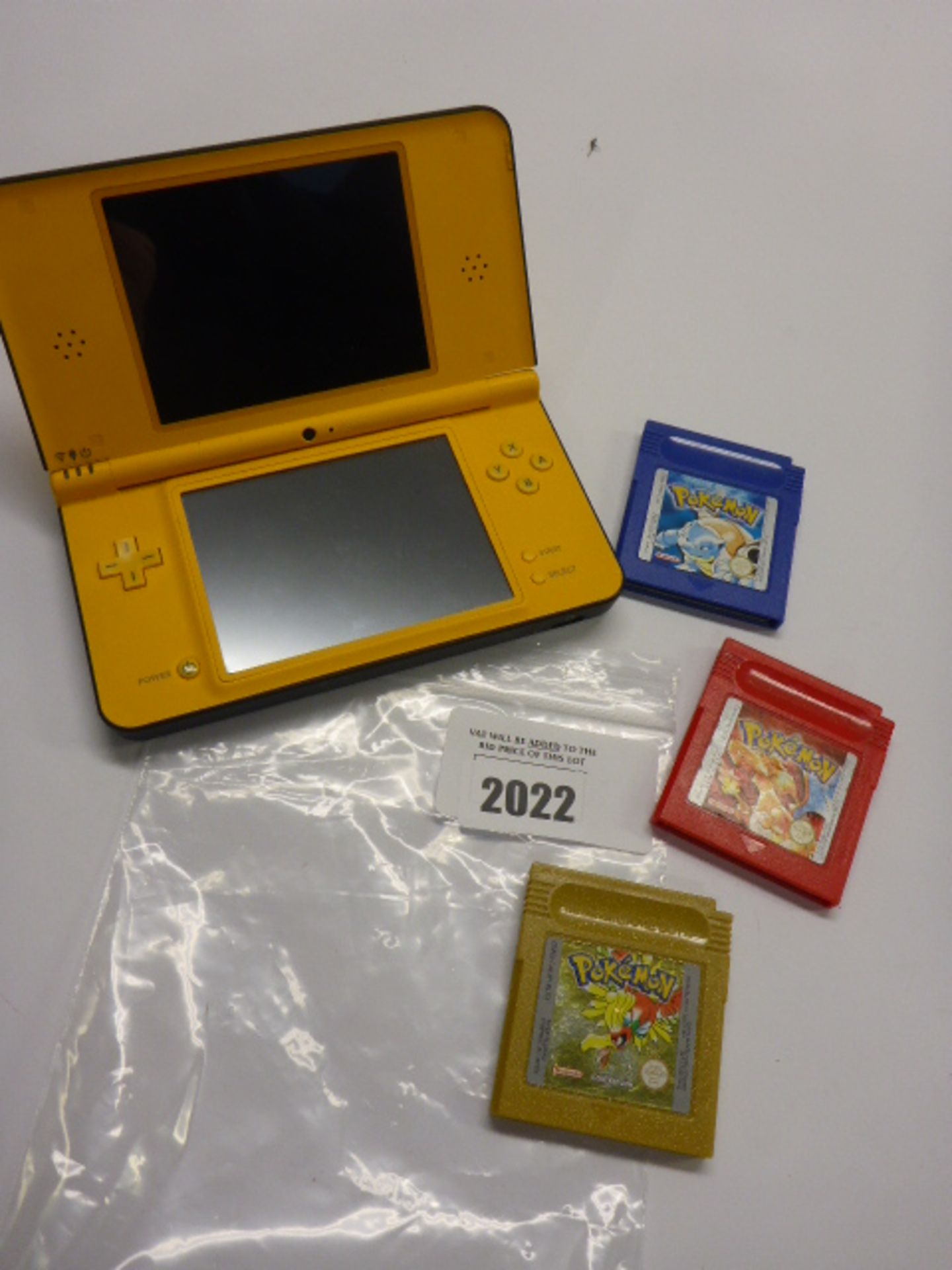 Nintendo DSi XL hand held console with Mario Kart game and three Gameboy Pokemon Games.