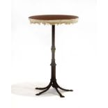 A brass occasional table, the circular surface on five splayed legs and claw feet, d.
