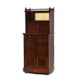 An Edwardian mahogany hall cabinet, the superstructure with a mirrored back,