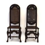 A pair of 17th century and later oak and bergere hall chairs on splayed front legs