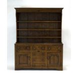 A late 18th/early 19th century oak and ebony inlaid Welsh dresser,