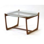 A Danish teak framed occasional table with a circular glass surface, d.