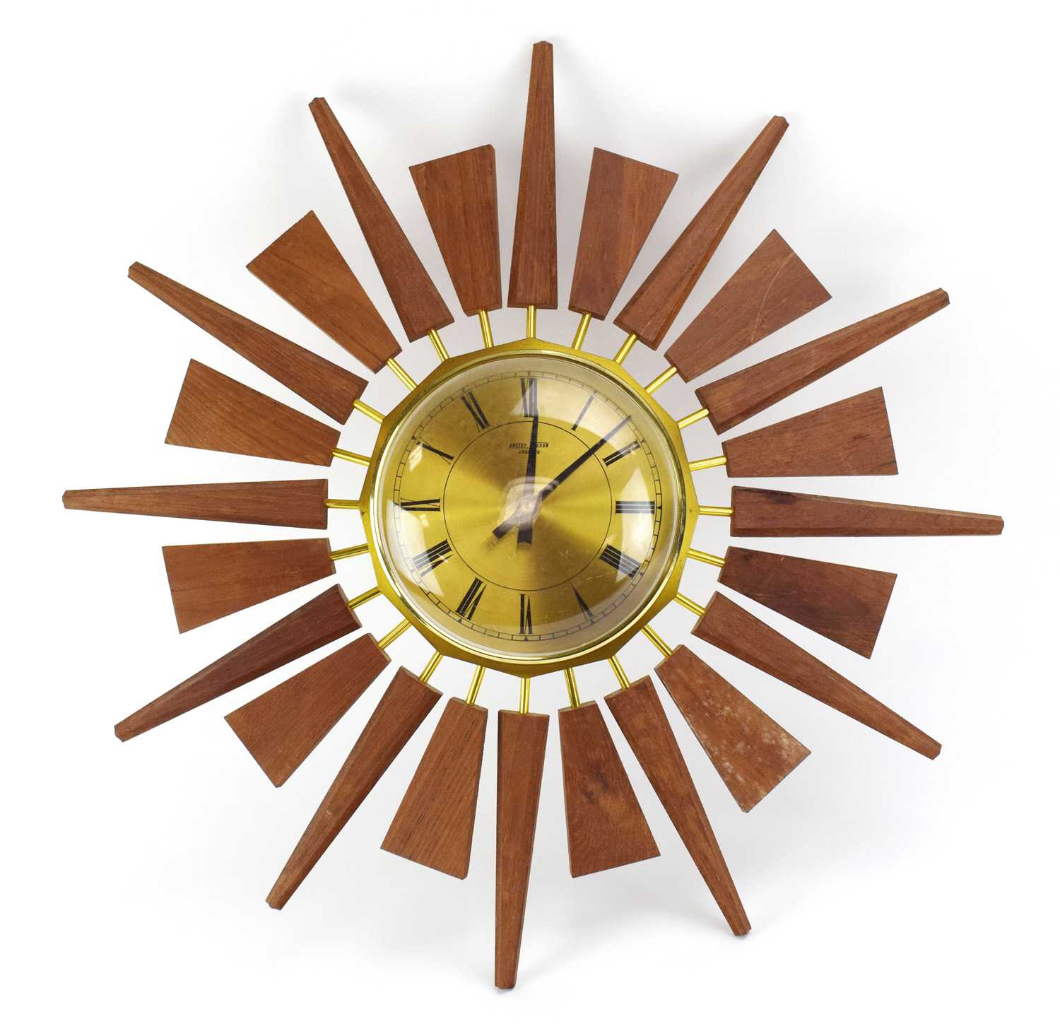 A 1970's teak and brass finished 'Sunburst' or 'Starburst' wall clock by Anstey & Wilson, d.