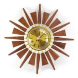 A 1970's teak and brass finished 'Sunburst' or 'Starburst' wall clock by Anstey & Wilson, d.