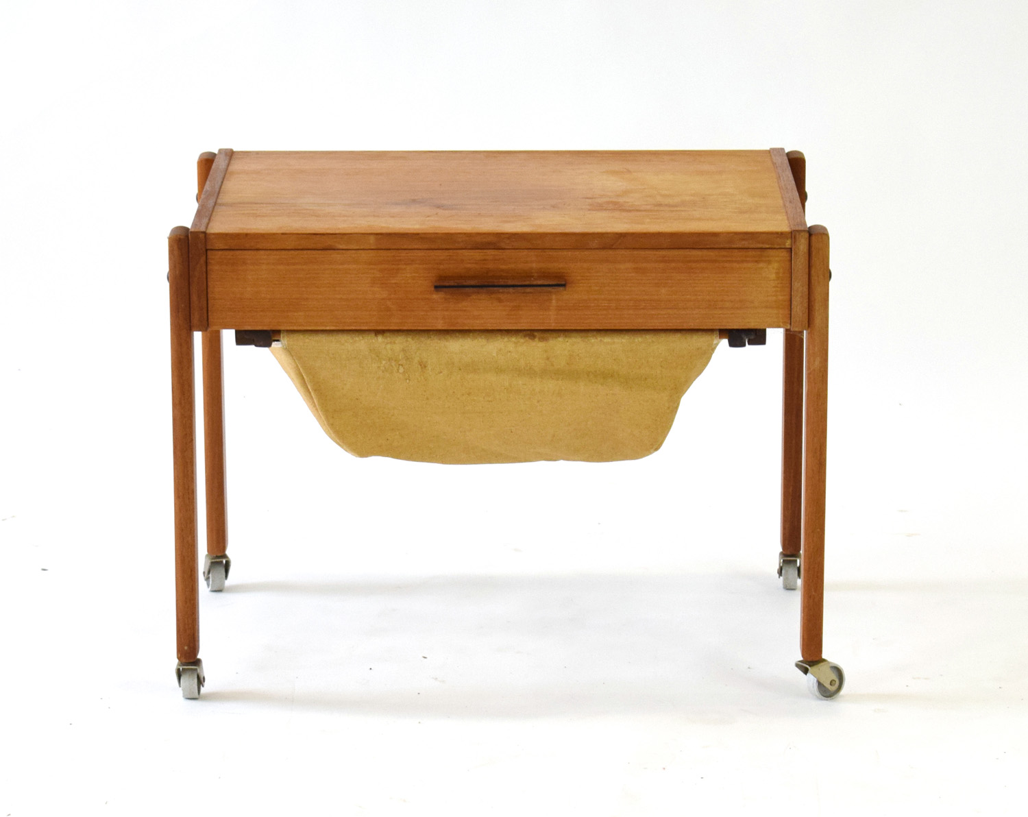 A 1960's Danish teak work table, the single drawer over a hobby basket,
