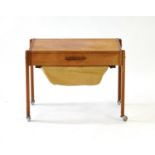 A 1960's Danish teak work table, the single drawer over a hobby basket,