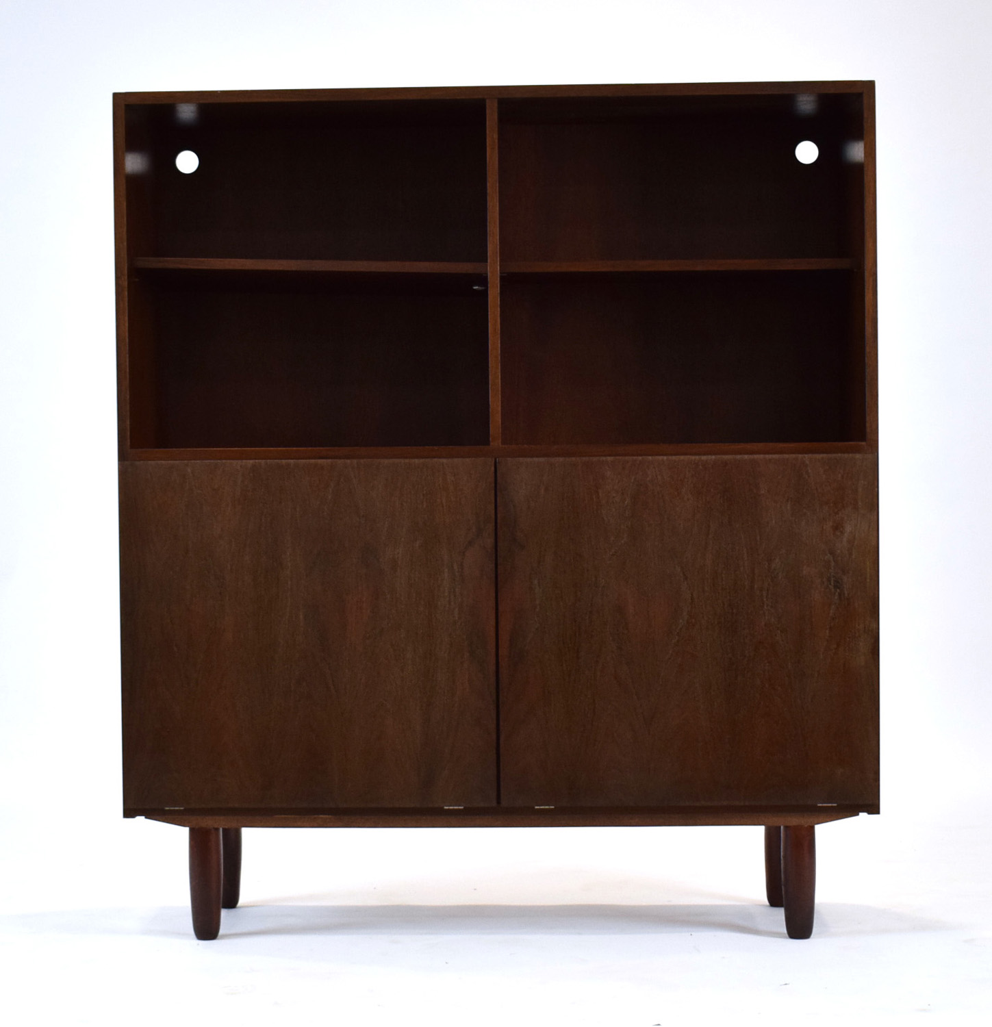 A 1960's Danish rosewood cabinet, the two adjustable shelves over two fall-front doors,