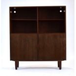 A 1960's Danish rosewood cabinet, the two adjustable shelves over two fall-front doors,