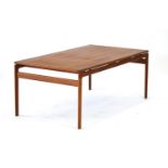 A 1960/70's teak and crossbanded occasional table 'floating' on curved supports,