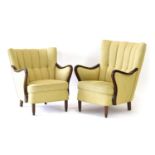 A pair of 1940's shell-shaped armchairs with stained beech frames and button upholstery