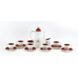 A Susie Cooper six-sitting coffee service decorated with red and gilt bands and petals