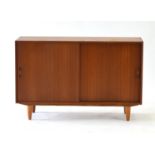 A 1960/70's Danish teak sideboard with two sliding doors, on turned legs, l.