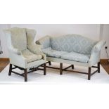 For Reupholstery: a Georgian-type three seater sofa with a shaped back on mahogany legs and