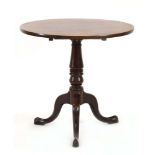 A George III mahogany table, the circular tilt-top on a column and three splayed legs, d.