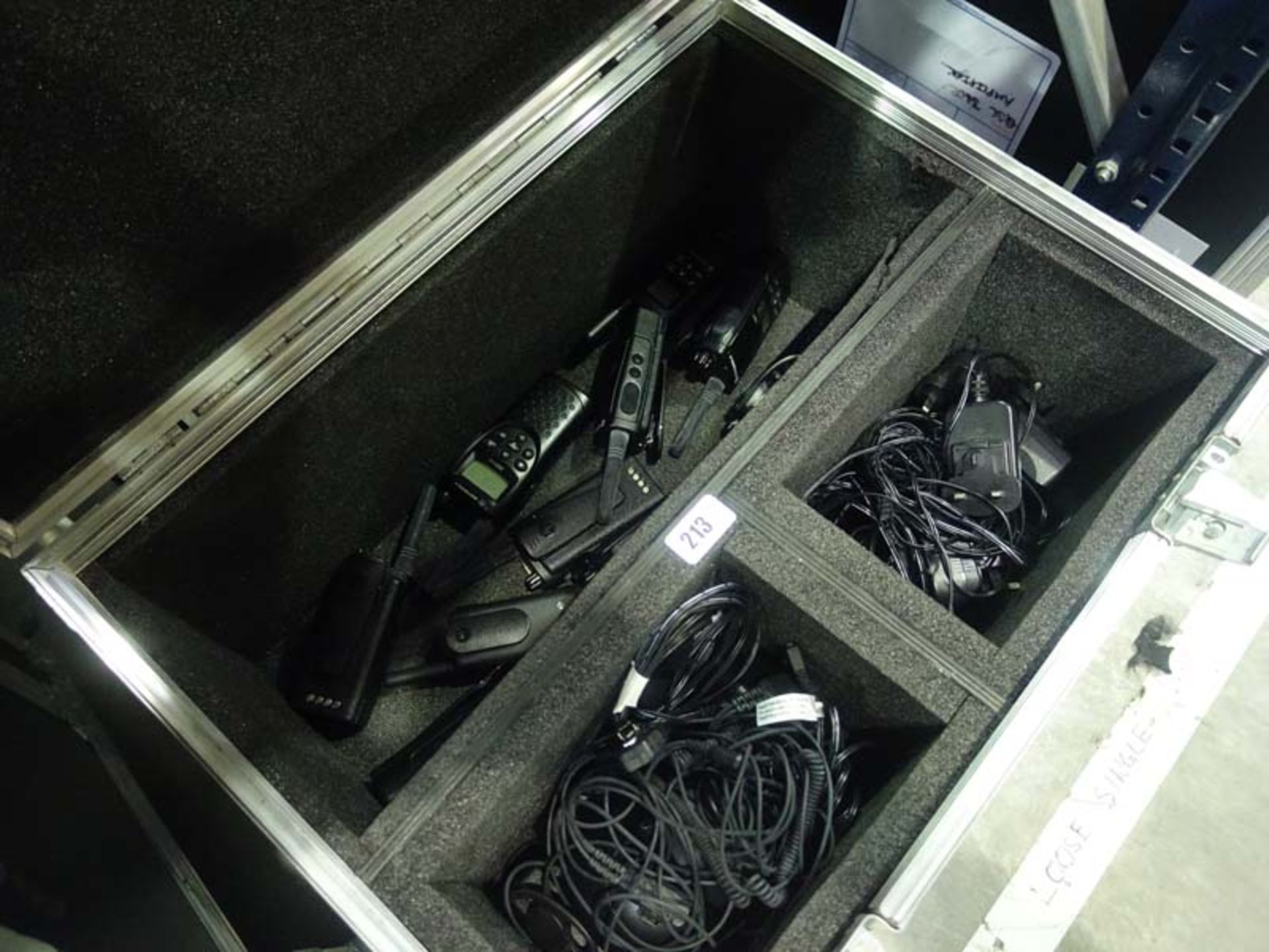 Freight case containing Motorola model XTNID walkie talkies with chargers and earpieces