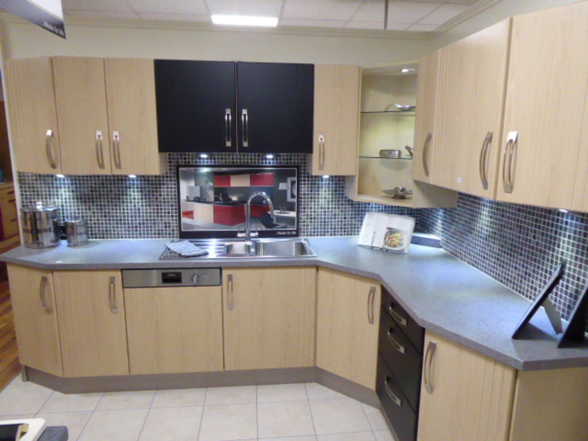 Springfield Swiss Pear Satin Black kitchen in L-shape with a grey granite effect worktop. Max