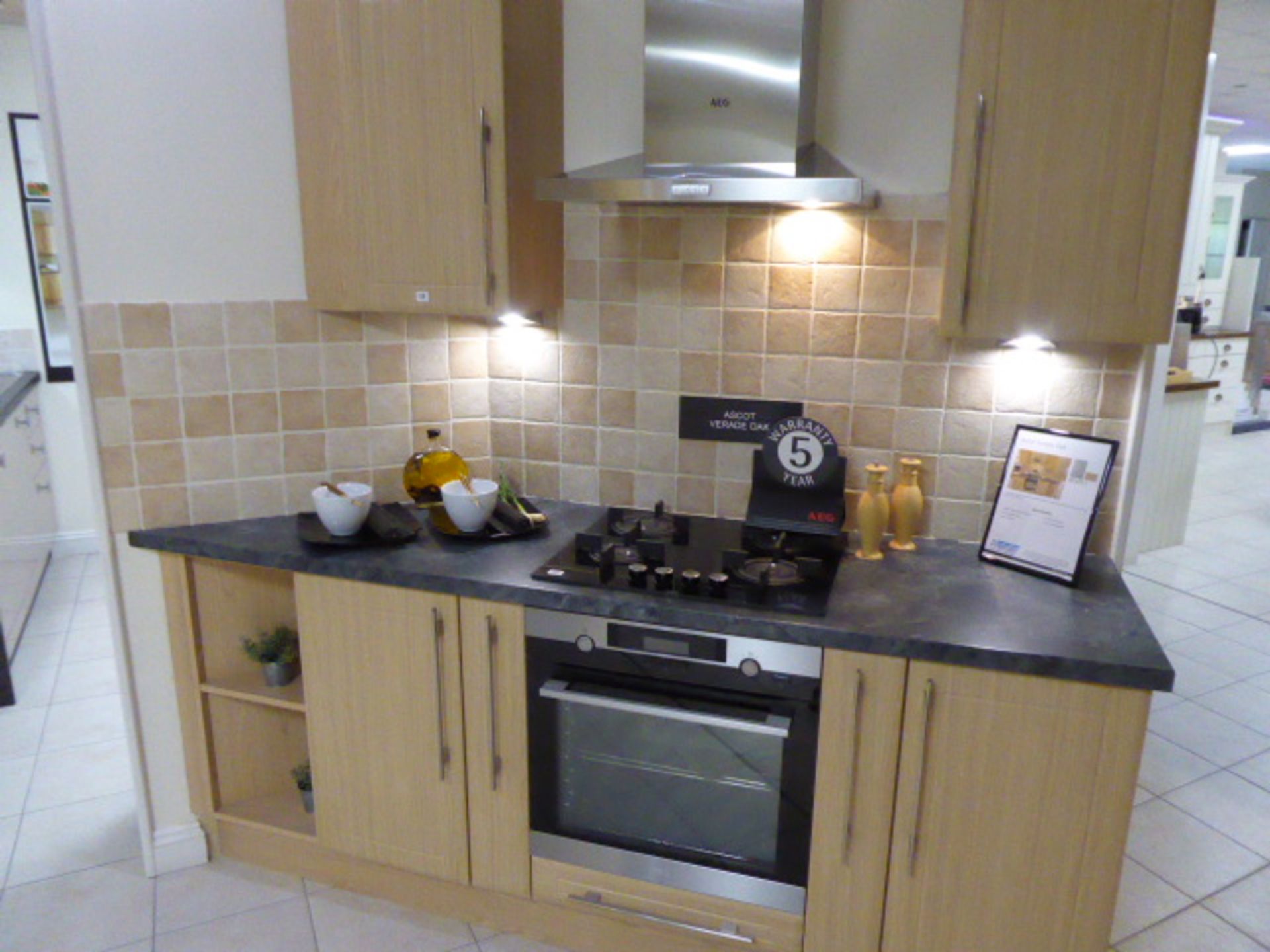 Ascot Verade Oak small kitchen with a grey granite effect worktop. Max dimension 215cm. With AEG