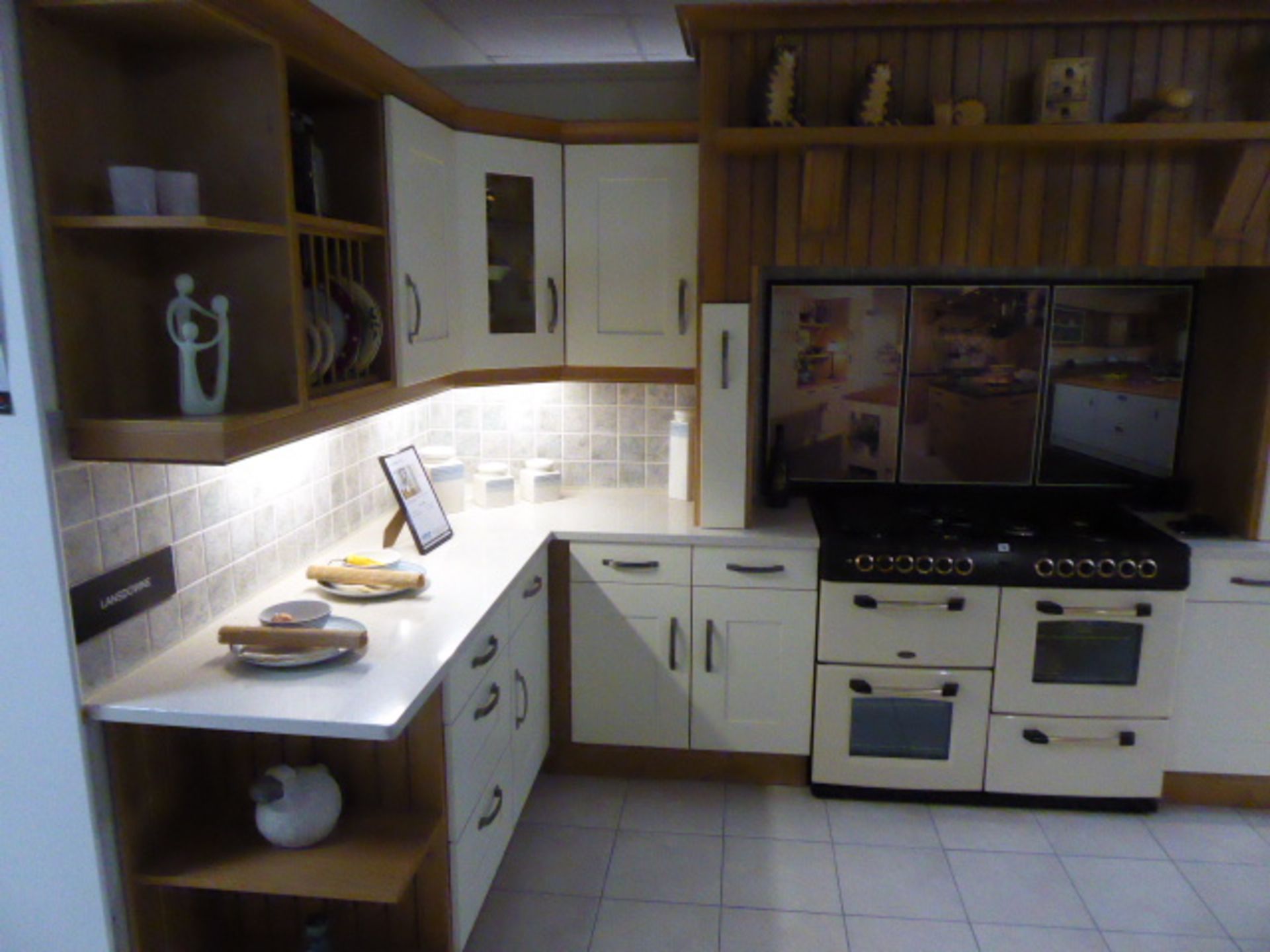 Landsdowne kitchen in L-shape with a composite stone worktop in cream. Max dimension 350cm by 195cm.