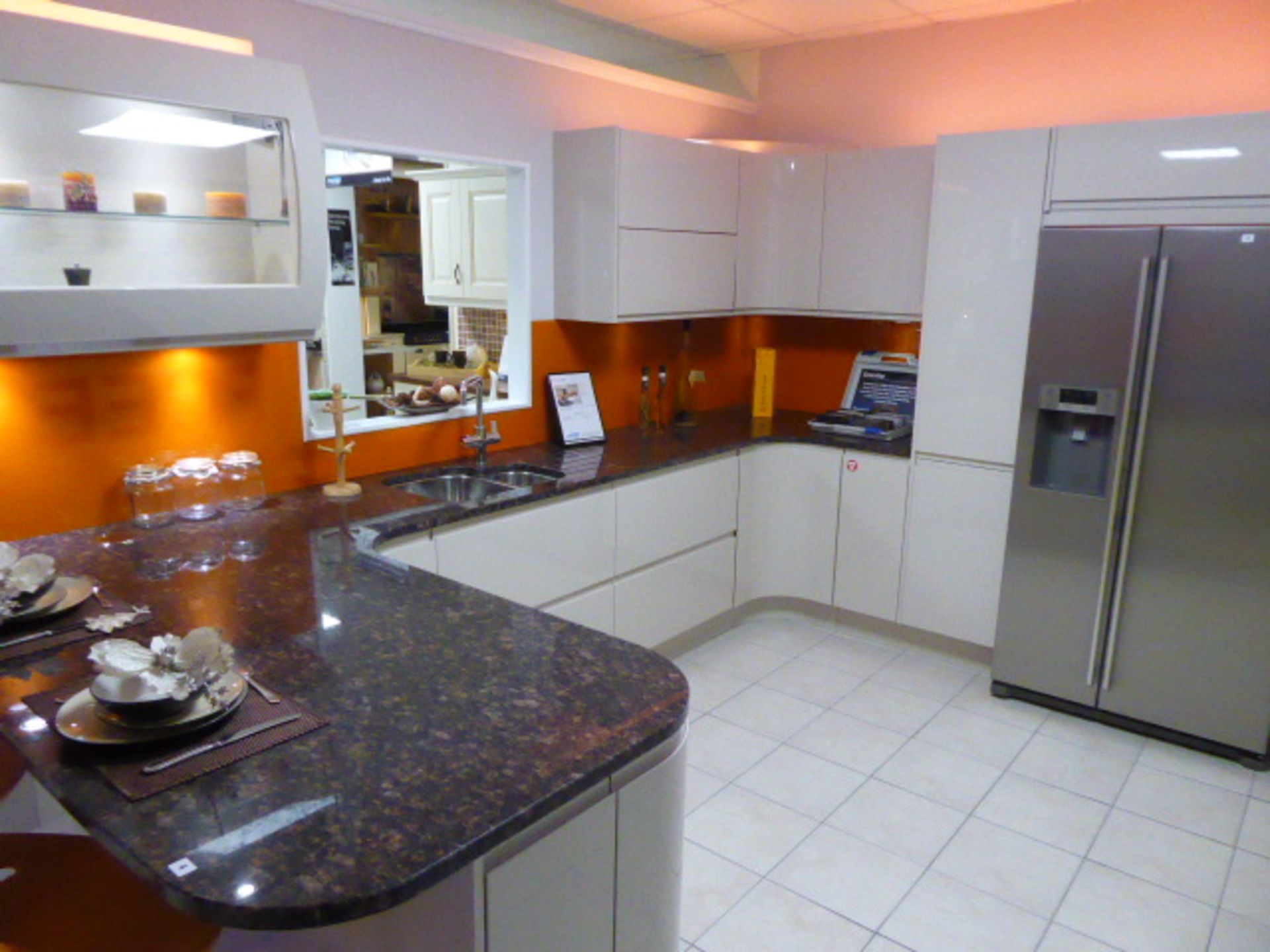 Remo Beige kitchen in a large L-shape with a granite tan brown worktop with additional floor