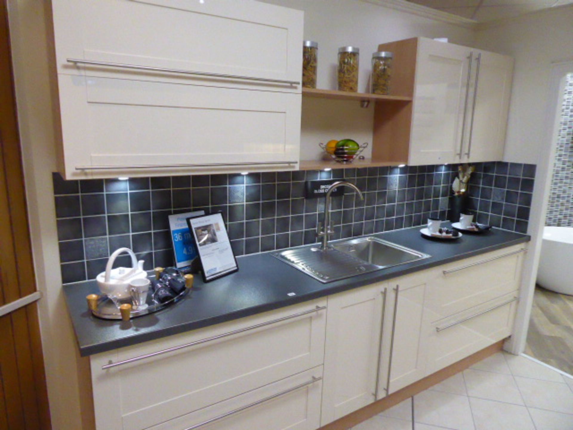 Décor Gloss Oyster kitchen with a grey granite effect worktop in single run galley. Max dimension