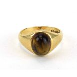 A 9ct yellow gold signet ring set cabochon tigers eye, ring size Q, 4.