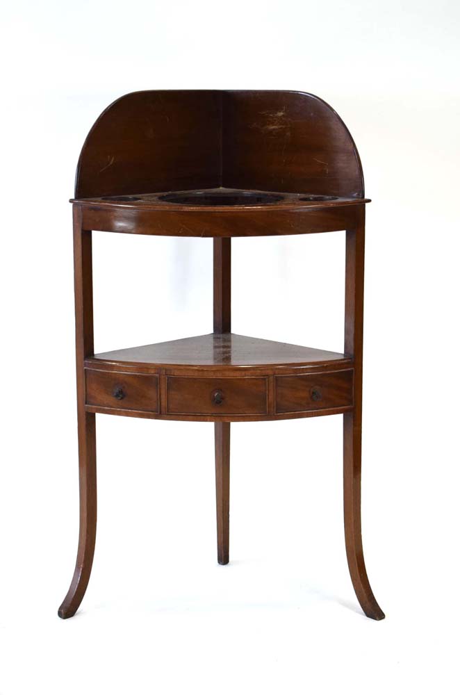 A Georgian mahogany corner washstand with a single drawer, on splayed legs, h.