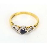 An 18ct yellow gold and platinum highlighted ring set brilliant cut sapphire and two small diamonds