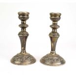 A pair of silver candlesticks of Neo-Classical design having scrolled decoration, maker B&Co.