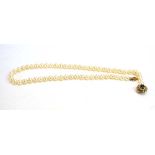 A single strand continuous cultured pearl necklace having a 9ct yellow gold clasp with heart shaped