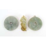 Two Chinese pale green jade disc pendants, both with shallow carving, max d. 5.