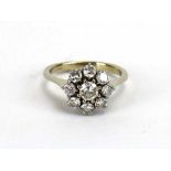 An 18ct white gold cluster ring set nine brilliant cut diamonds in a flowerhead setting,
