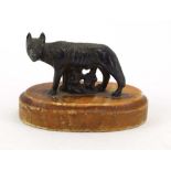 After the Antique, 'The Capitoline Wolf', bronze modelled as Romulus and Remus, on a marble plinth,