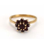 A 9ct yellow gold flowerhead ring set garnet, ring size N,