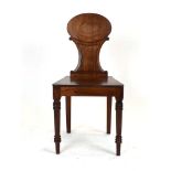 A William IV mahogany hall chair with an oval shaped back over a solid seat,