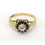 A 9ct yellow gold cluster ring set diamond and small sapphires in an illusion setting, ring size N,
