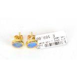 A pair of 18ct yellow gold ear studs, each set oval opal in a rubover setting, l. 7 mm, 2.