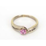 An 18ct white gold crossover ring centrally set brilliant cut pink sapphire,